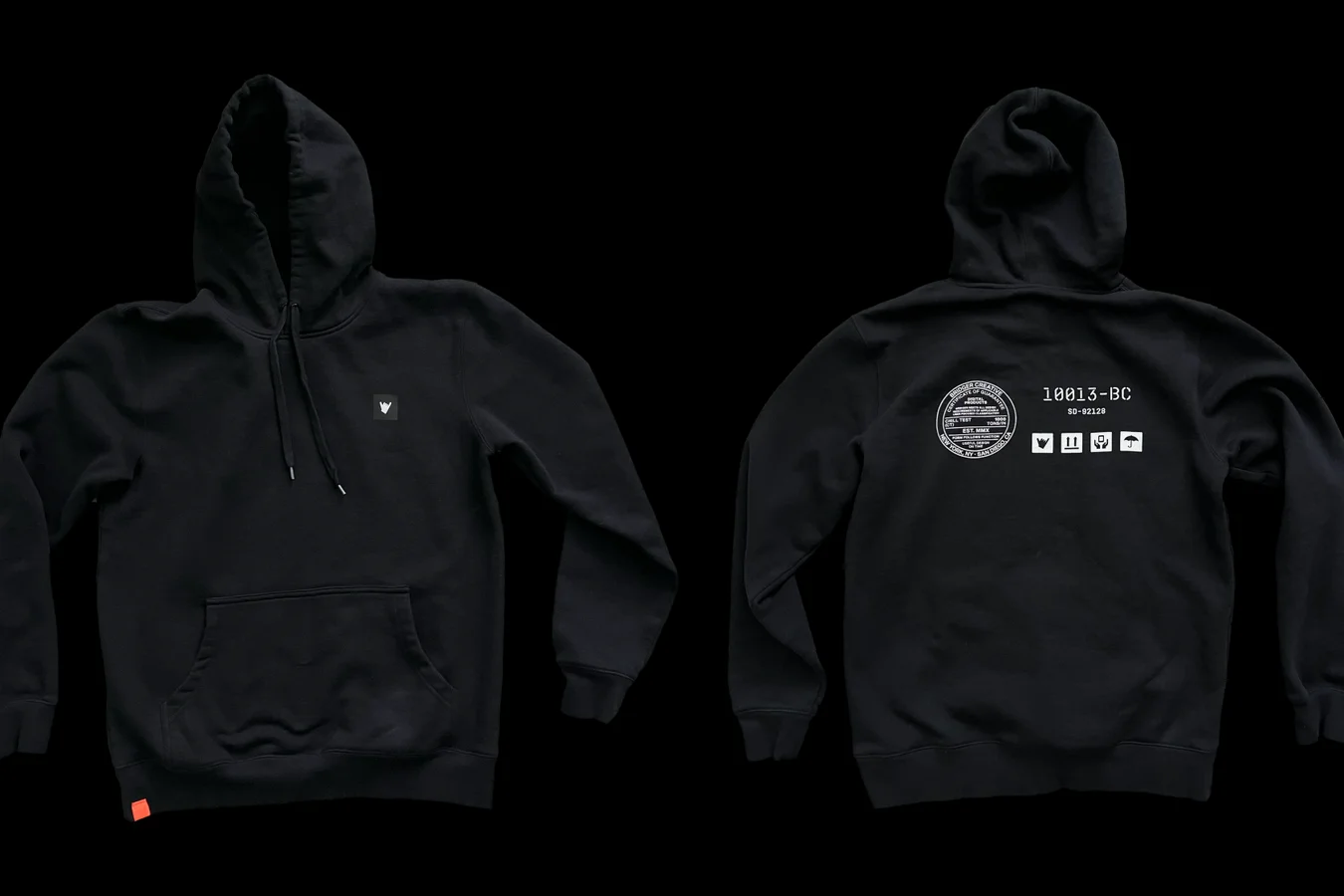 Front and back of a black hoodie on black, a small triangle mark on the chest and a small seal with icons on the back