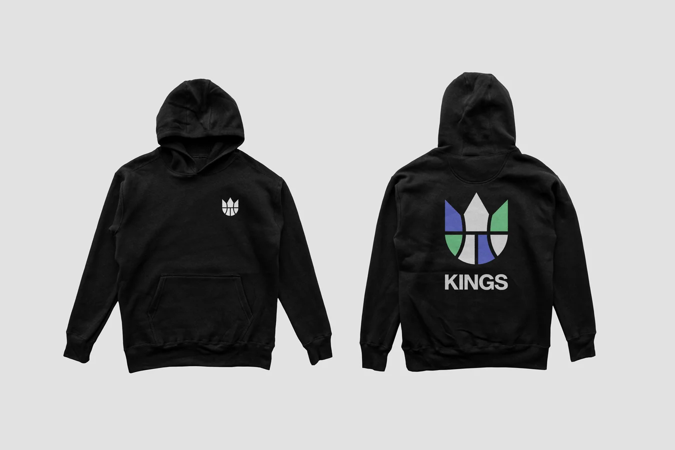 Front and back of a black hoodie, a small white crown mark on the chest and a green, blue and white crown mark above KINGS on the back
